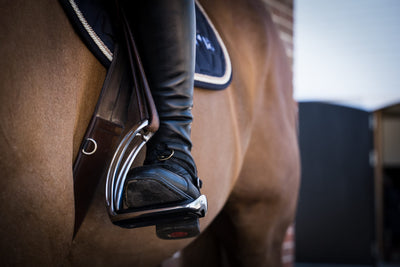 Where should your foot be in the safety stirrups?