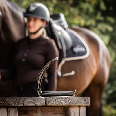 How can safety stirrups help dressage riders?